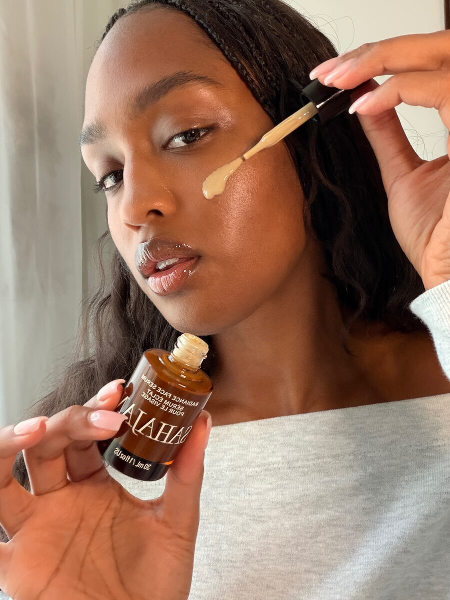 Bailey applying Radiance Face Serum with the dropper
