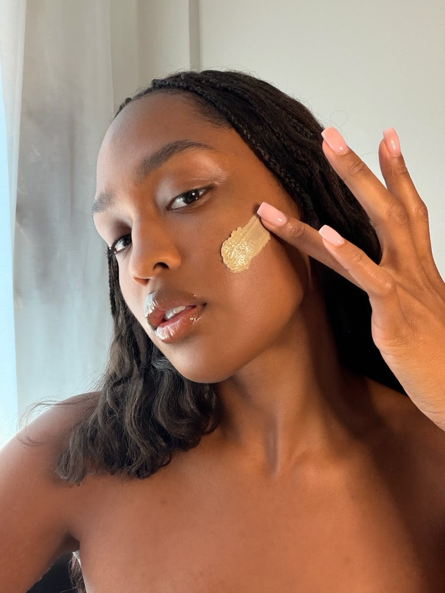 Bailey smoothing the Nourish Creme Riche onto her cheek